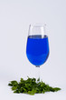 A glass filled with blue substance