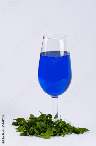 Photo: A glass filled with blue substance A glass filled with blue substance