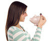 Ethnic Female Putting Coin Into Piggy Bank on White