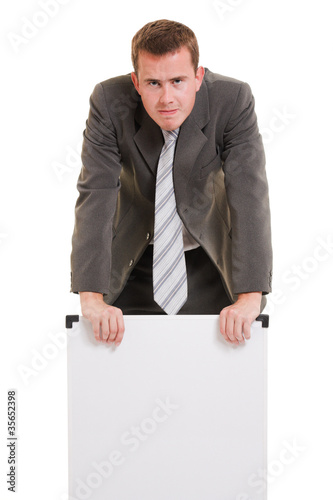 Photo: Man holding a white board. Man holding a white board.