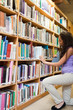 Portrait of a female student choosing a book