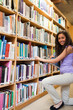 Portrait of a smiling female student choosing a book