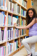 Portrait of a cute female student choosing a book
