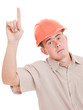 Businessman in helmet pointing up.