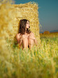 beautiful nude woman sitting near hay stack beautiful nude woman sitting near hay stack