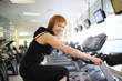Photo: Woman exercising on bike Woman exercising on bike