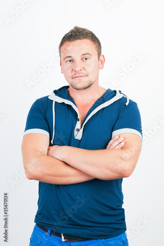 Photo: Goodlooking young man smiling confidently. Goodlooking young man smiling confidently.