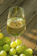 wine and grapes on wooden table