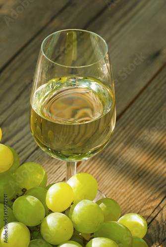 Photo: wine and grapes on wooden table wine and grapes on wooden table