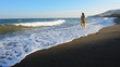 Video: Girl goes on seacoast against a sea surf Girl goes on seacoast against a sea surf