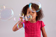 Photo: Little African Asian girl blowing soap bubbles Little African Asian girl blowing soap bubbles