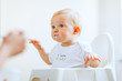 Photo: Eat smeared lovely baby in baby chair feeding by mother Eat smeared lovely baby in baby chair feeding by mother