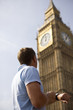 A man checking his watch next to Big Ben