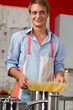 Photo: Handsome man cooking in the kitchen at home Handsome man cooking in the kitchen at home