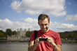 A man looking at his photographs on his phone