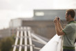 A man on the Millennium Bridge, taking a photograph