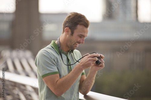 Photo: A man looking at his photographs on his camera A man looking at his photographs on his camera