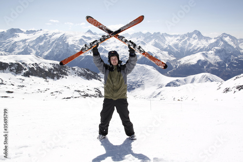 Photo: Man holding skis up Man holding skis up