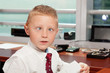 Photo: Cute boy with goofy face in business attire in an office Cute boy with goofy face in business attire in an office