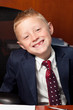Photo: Cute goofy boy in business attire in an office Cute goofy boy in business attire in an office
