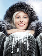 Nice woman with warm coat and winter tires in the snow