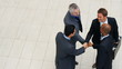 High angle view of cooperative business men shaking hands