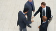 High angle view of successful business men shaking hands
