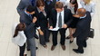 High angle view of multi racial business people reading contract