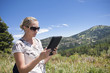 Woman using tablet computer outdoors Woman using tablet computer outdoors