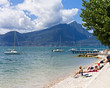 Foto: people relaxing at the beach of Lake Garda at Torri del Benaco people relaxing at the beach of Lake Garda at Torri del Benaco