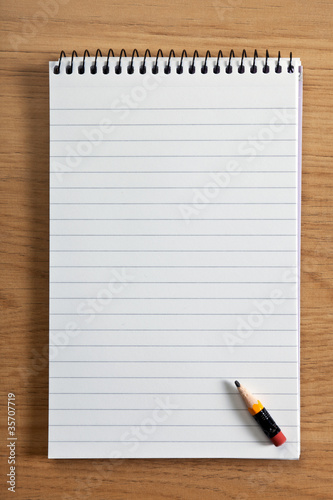 Photo: Blank notepad and pencil Blank notepad and pencil
