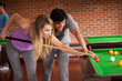 Young couple playing snooker