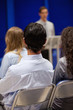 Portrait of young people listening to a man