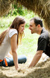 Young women and man in haystack Young women and man in haystack