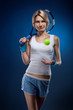 smiling woman with a tennis ball and racquet on blue