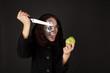 Two-faced witch with green apple and knife