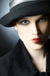 Fashion portrait of beautiful woman in black hat