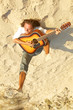 Image : Guitar player at sunset on the beach