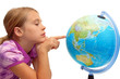 Schoolgirl pointing at globe