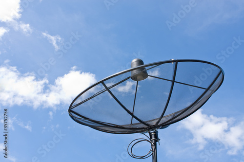 Photo: satellite dish and cloudy blue sky background satellite dish and cloudy blue sky background
