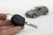 Keys and a car in the background