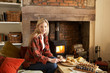 Photo: Young woman having tea by fire Young woman having tea by fire