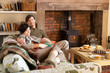 Young couple relaxing by fire