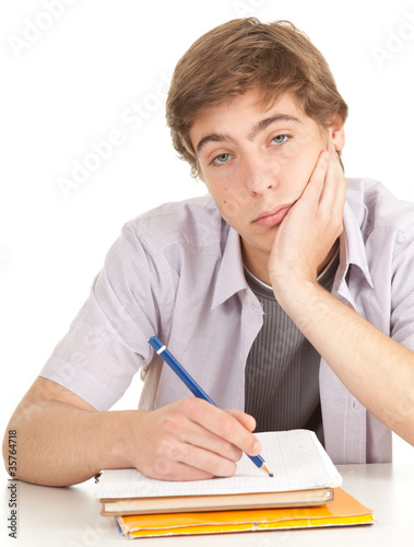 Photo: writing young male student with books, series writing young male student with books, series
