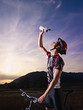 Photo: portrait of man training on mountain bike at sunset portrait of man training on mountain bike at sunset