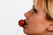 Profile of young woman with lollipop between her lips