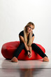 Young woman sitting on pouf
