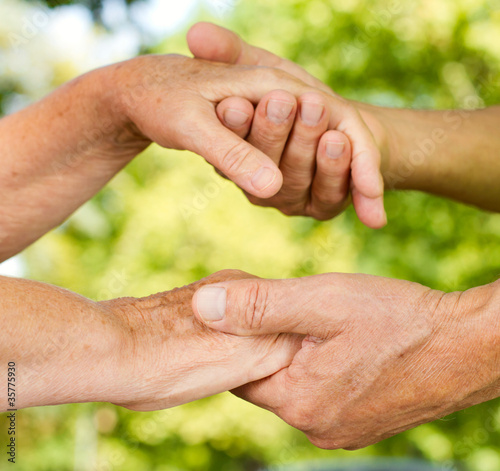 Photo: Closeup of senior hands holding together Closeup of senior hands holding together
