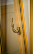 Photo: Gold window handle on laminated frame Gold window handle on laminated frame