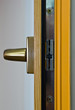 Photo: Gold window handle on laminated frame Gold window handle on laminated frame